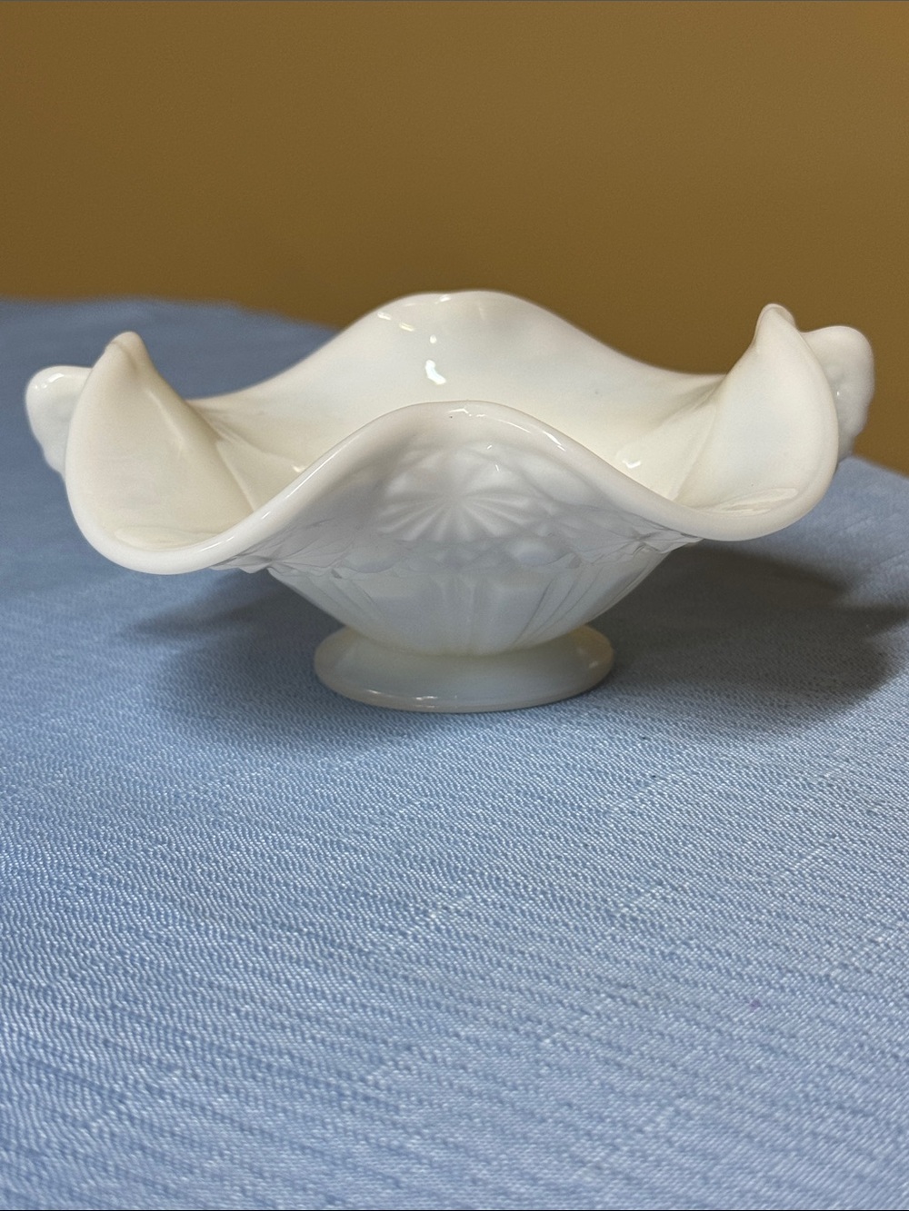 Fenton Daisy and Button milk glass footed candy dish with a crimped lip 5.5”